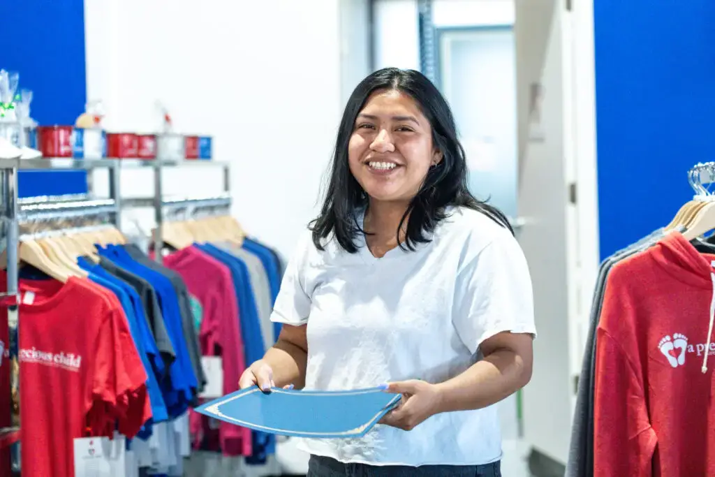 A young woman working in a mock store for the Pathways program